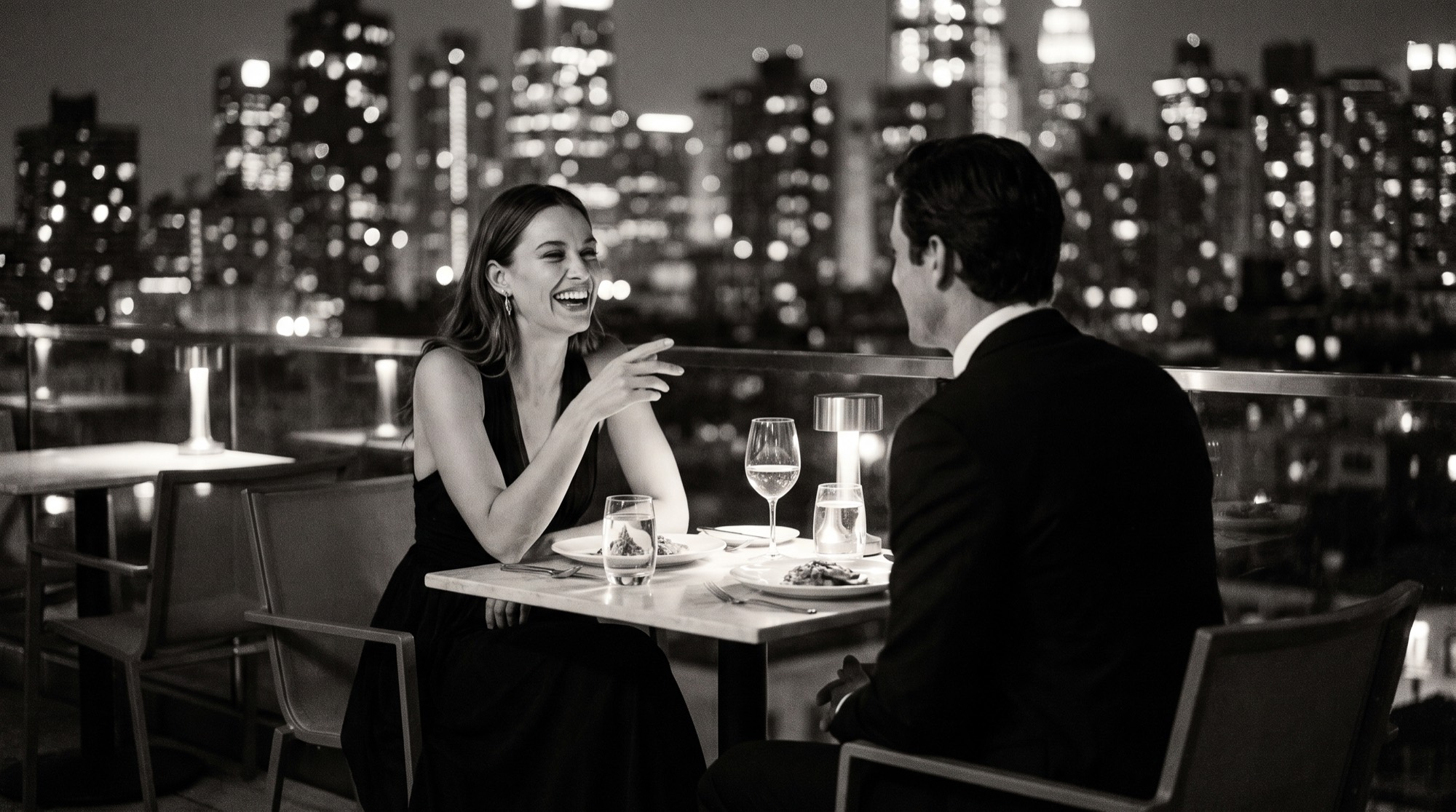 A woman leading the conversation at a rooftop dinner.